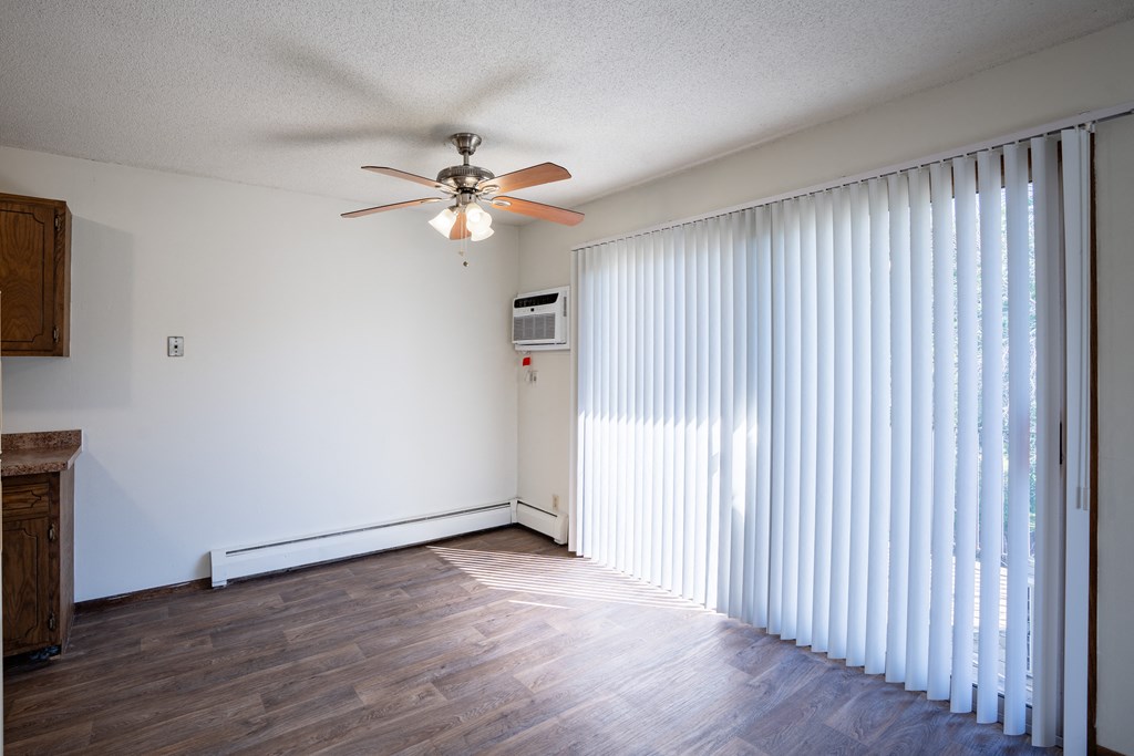a dining room with curtains and a ceiling fan. Eagan, MN Glen Pond Apartments