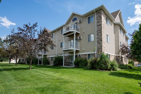 A large apartment building with a balcony on the second floor.