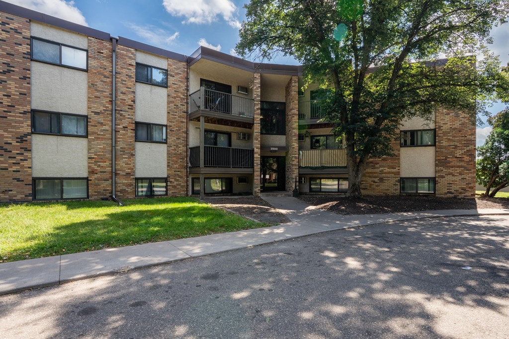 A large apartment complex with a tree in front. White Bear Lake, MN White Bear Terrace Apartments