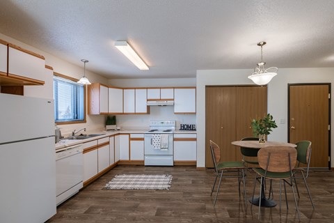 a kitchen and dining room with a table and chairs