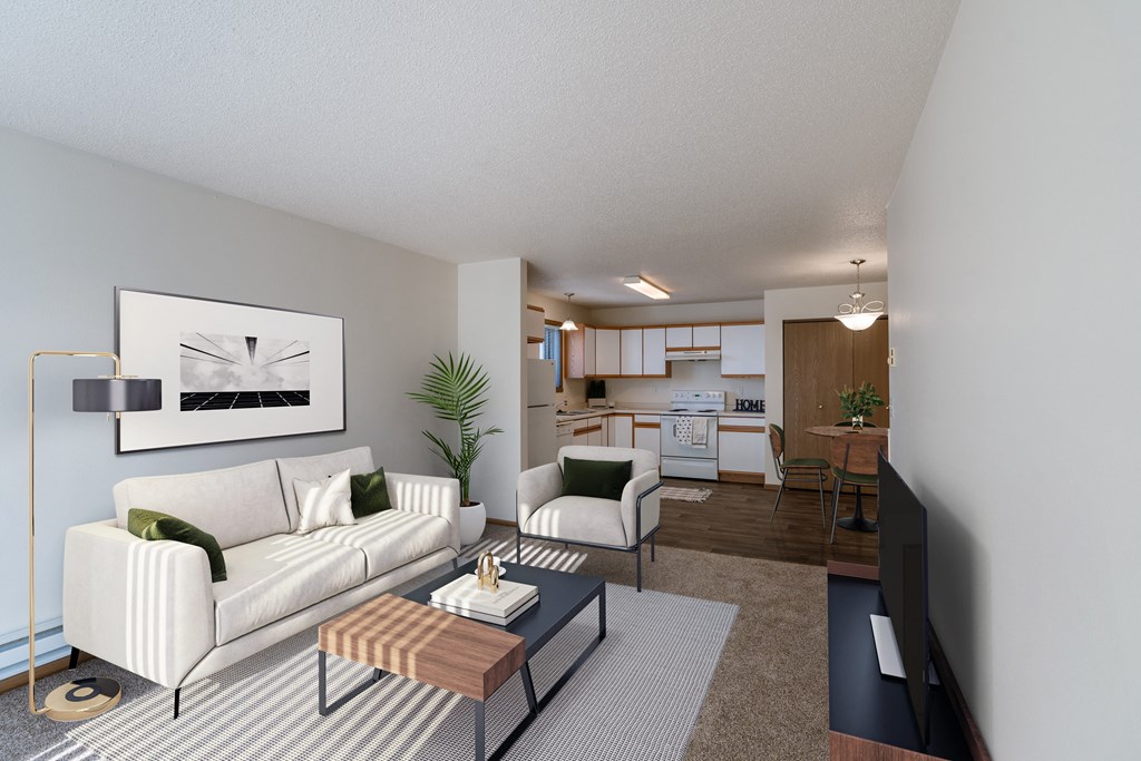 a living room with a white couch and a coffee table. Fargo, ND Eagle Run Apartments