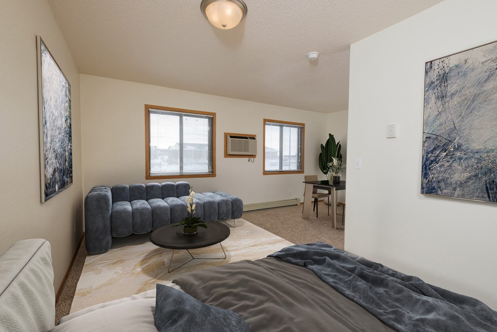Fargo, ND Ashbury Apartments. a bedroom with a couch and a table