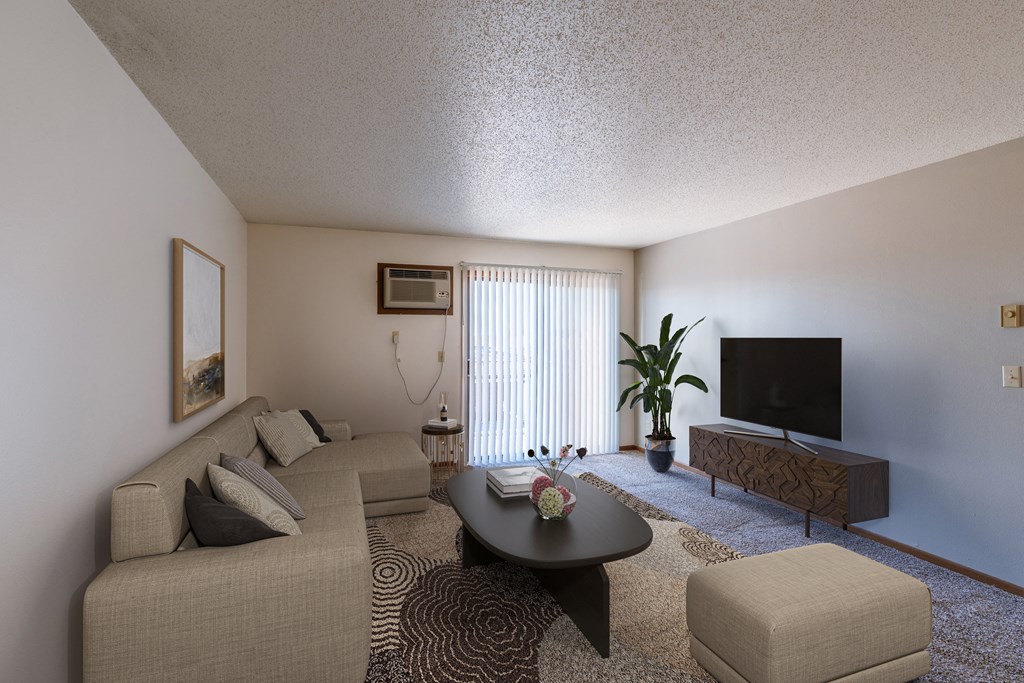 a living room with a couch and a coffee table and a tv. Fargo, ND Auburn II Apartments