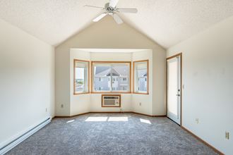Fargo, ND Bayview Apartments. A living room with a ceiling fan