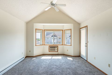 Fargo, ND Bayview Apartments. A living room with a ceiling fan