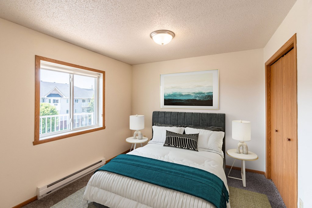 Fargo, ND Bayview Apartments. A bedroom with a bed and two windows