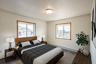 Fargo, ND Bayview Apartments. A bedroom with a bed and two windows