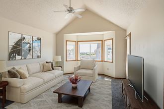 Fargo, ND Bayview Apartments. A living room with a vaulted ceiling and a large window