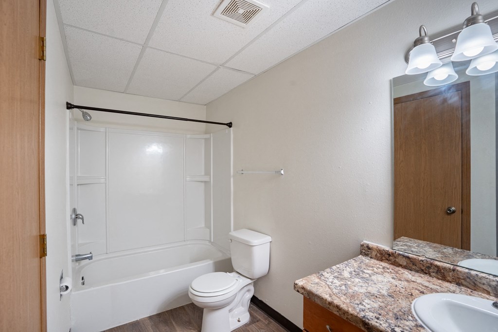 a bathroom with tub sink and toilet. Fargo, ND Bella Vista Apartments