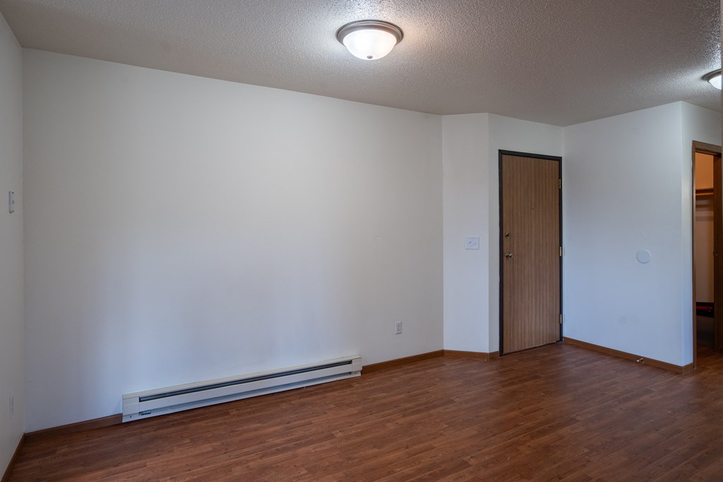 a dining room with wood flooring and white walls. Fargo, ND Briar Pointe Apartments
