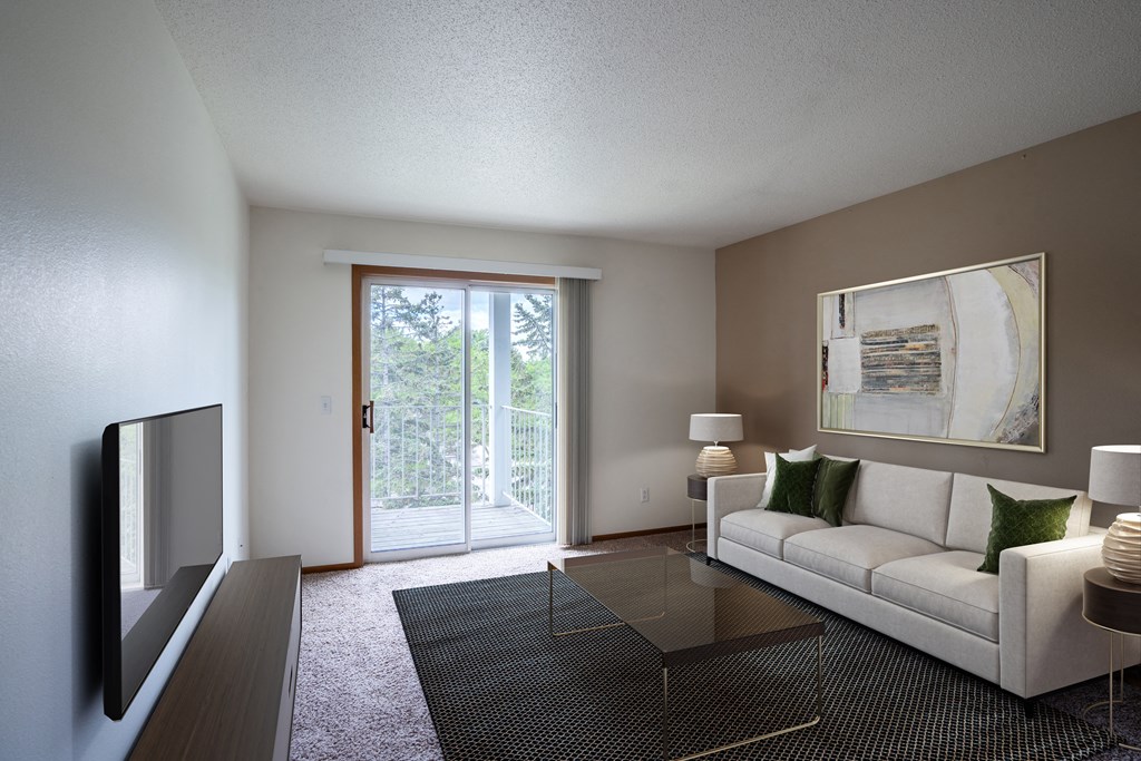 a living room with a white couch and a glass table. Fargo, ND Briar Pointe Apartments