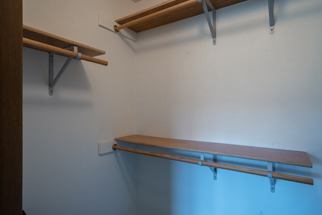 a wall mounted wooden shelf in a closet. Fargo, ND Brownstone Apartments