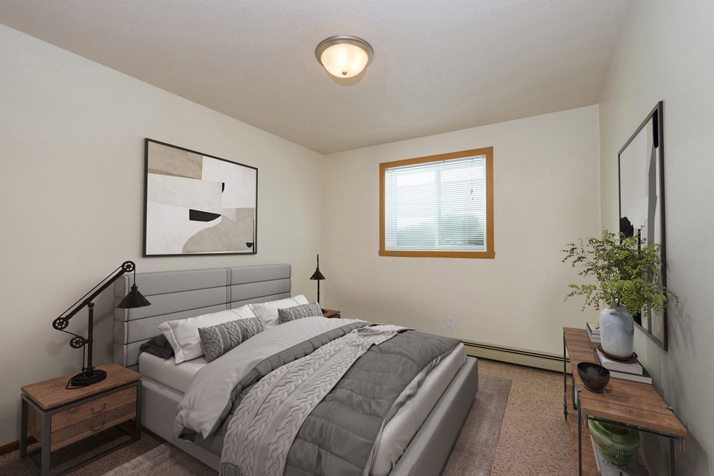 Fargo, ND Cambridge Apartments a bedroom with a large bed and a window