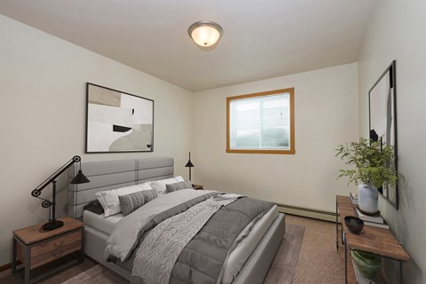 Fargo, ND Cambridge Apartments a bedroom with a large bed and a window