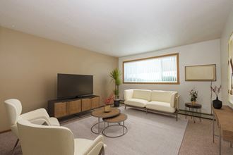 Fargo, ND Cambridge Apartments a living room filled with furniture and a flat screen tv