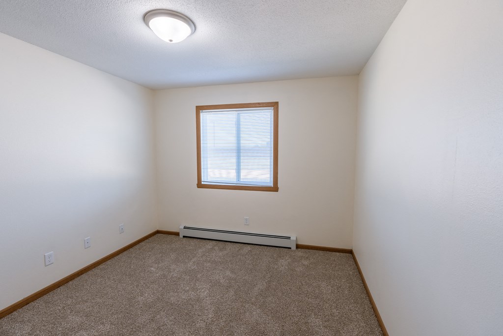 Fargo, ND Cambridge Apartments. A bedroom with white walls and a window