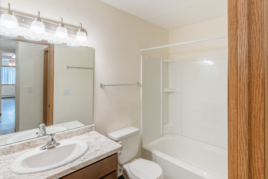 Fargo, ND Cambridge Apartments. A bathroom with a sink toilet and bathtub