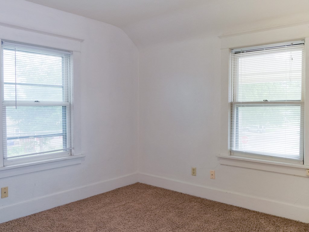 Fargo, ND Cityside Apartments  a small bedroom with two windows and a carpeted floor