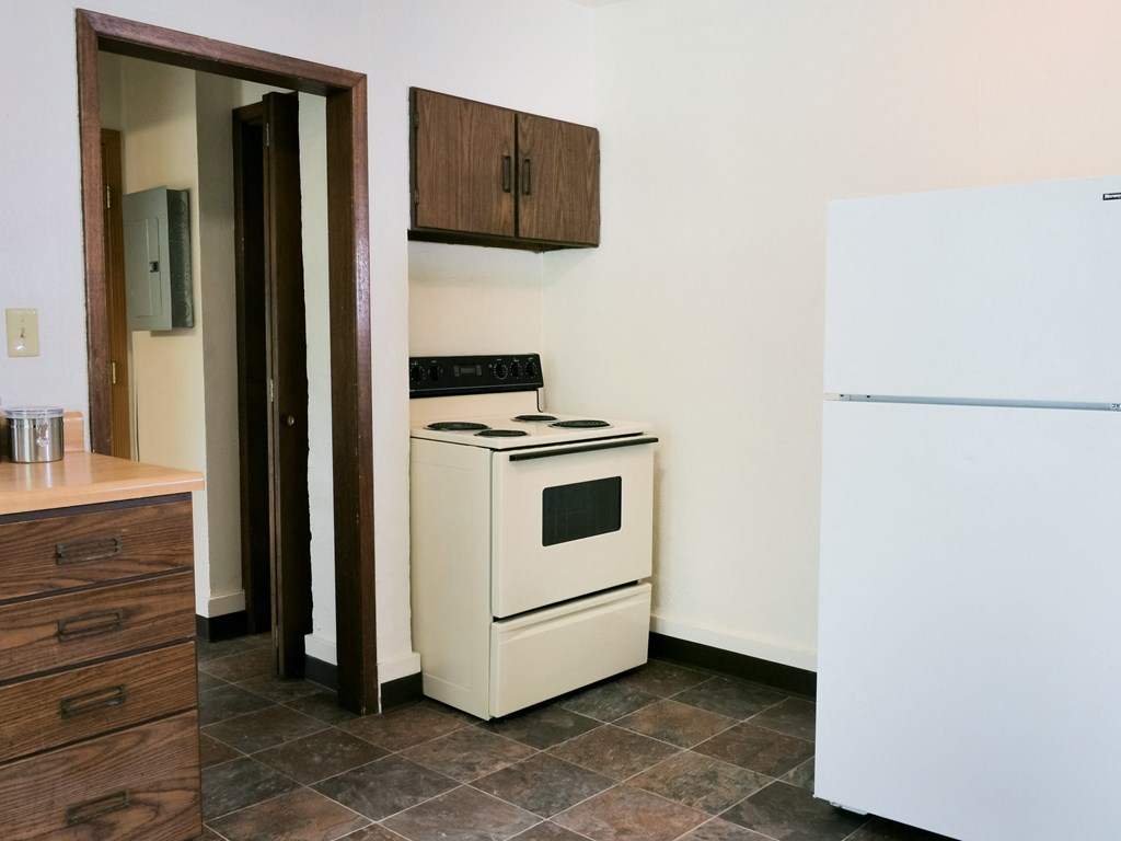 Fargo, ND Cityside Apartments. A kitchen with a white stove and refrigerator