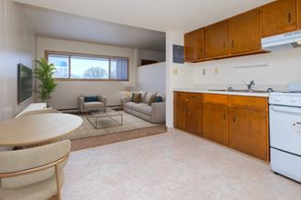 Fargo, ND Cityside Apartments.  a kitchen with a stove top oven next to a table and chairs