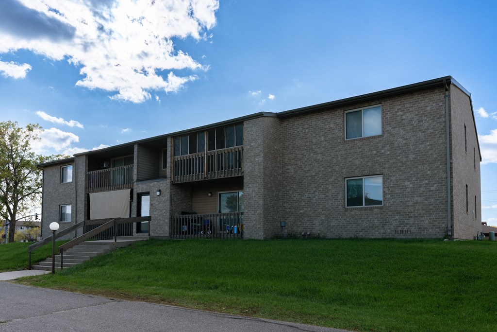 Fargo, ND Clearview Apartments | Exterior an exterior view of a brick apartment building with green grass