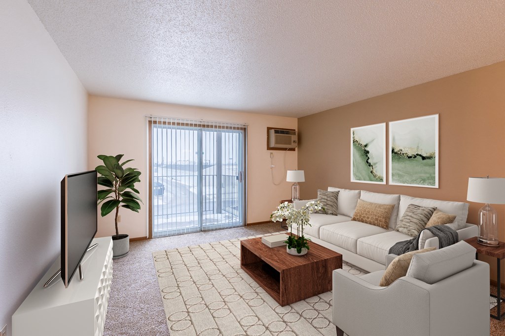 a living room with a white couch and a tv. Fargo, ND Country Edge Apartments