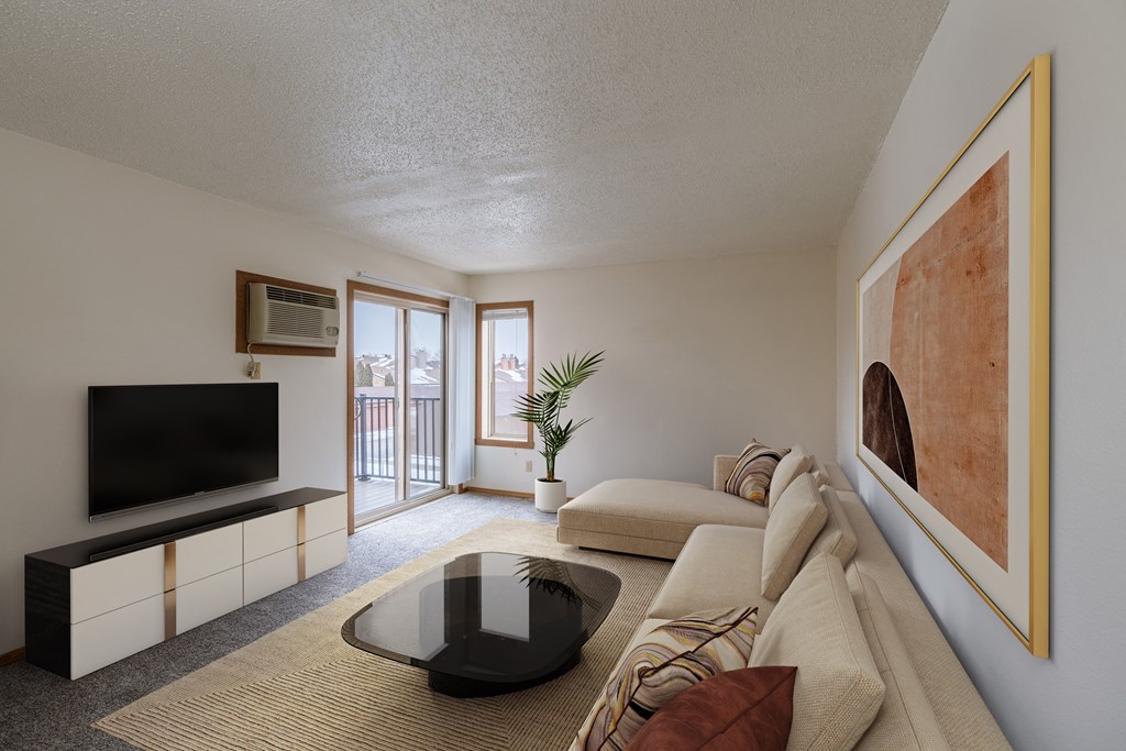 a living room with a couch and a coffee table and a tv. Fargo, ND Crescent Park Apartments