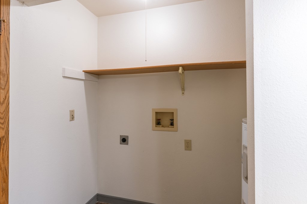 an empty room with white walls and a wooden beam on the ceiling. Fargo, ND Crescent Park Apartments