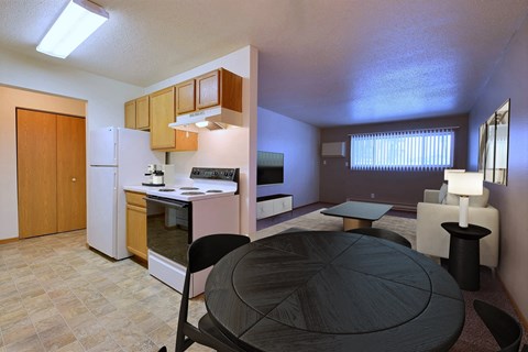 a kitchen and dining room with a table and a refrigerator