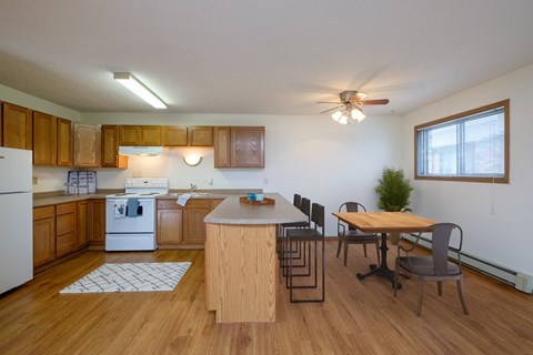 an open kitchen and dining room with a table and chairs