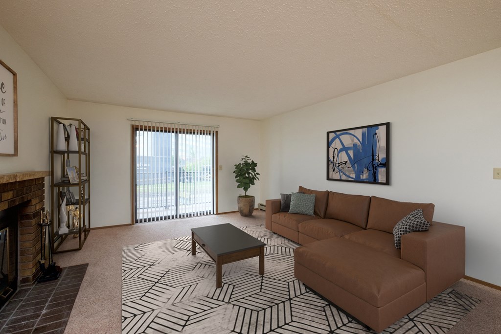 Fargo, ND Dynasty Apartments a living room with a couch coffee table and fireplace