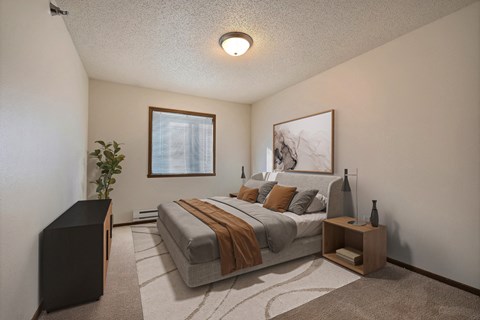 the view of a bedroom with a bed and a window. Fargo, ND Eagle Run Apartments