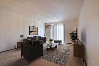 a living room with a couch and a coffee table. Fargo, ND Eagle Run Apartments