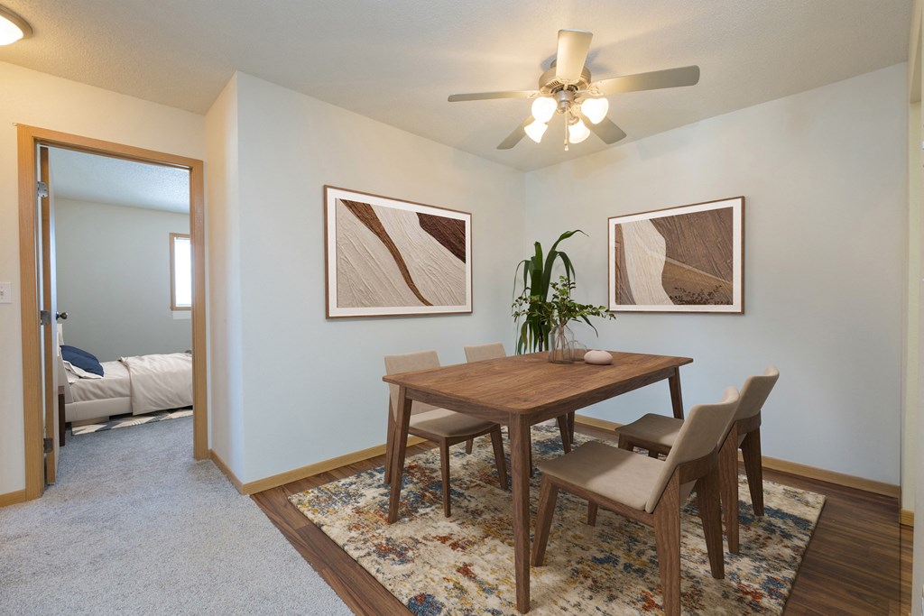 Fargo, ND Essex Apartments. The room showcases a modern dining table, comfortable seating, and tasteful decor, creating an inviting and enjoyable space for meals and gatherings.
