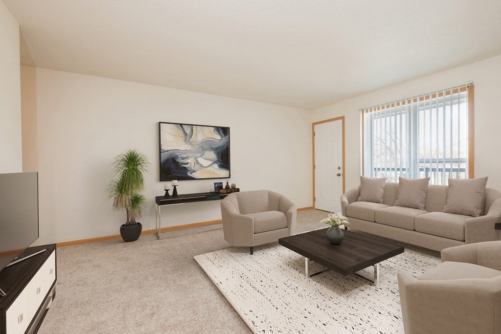 Fargo, ND Essex Apartments. A bright living room with two couches and a coffee table. A large window brightens the room with natural light.