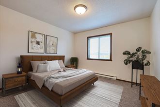 Fargo, ND Flagstone Apartments. a bedroom with a large bed and a window