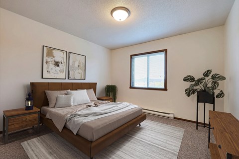 Fargo, ND Flagstone Apartments. a bedroom with a large bed and a window
