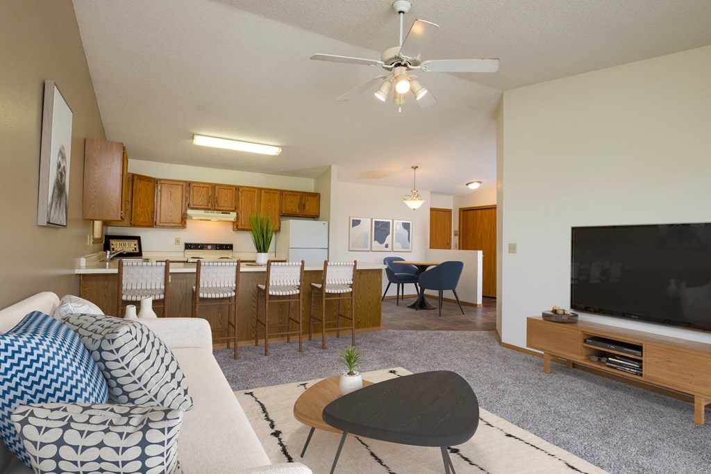 Fargo, ND Flickertail Apartments a living room with a couch and a table in front of a tv