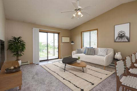 Fargo, ND Flickertail Apartments a living room with beige walls and a sliding glass door leading to a balcony