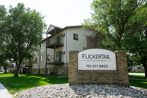 Fargo, ND Flickertail Apartments. Exterior of an apartment building with a sign that says Flickertail outside.