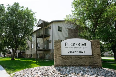 Fargo, ND Flickertail Apartments. Exterior of an apartment building with a sign that says Flickertail outside.