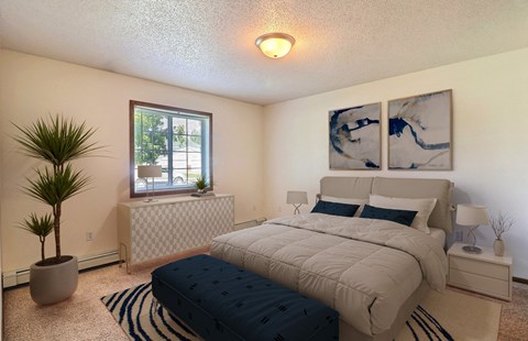 Fargo, ND Foxboro Townhomes. a bedroom with a large bed and a window