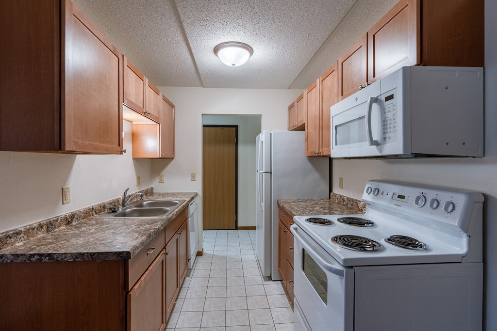 a kitchen with white tile floors and white appliances at France, Fargo, ND 58103