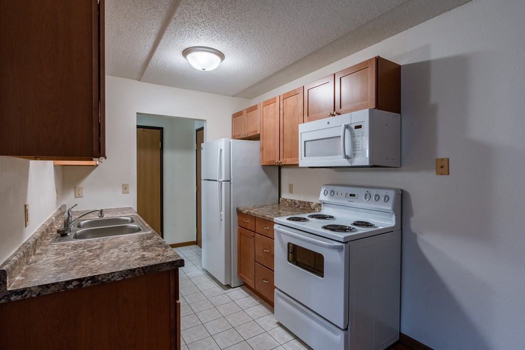 a kitchen with white tile flooring and white appliances at France, North Dakota, 58103