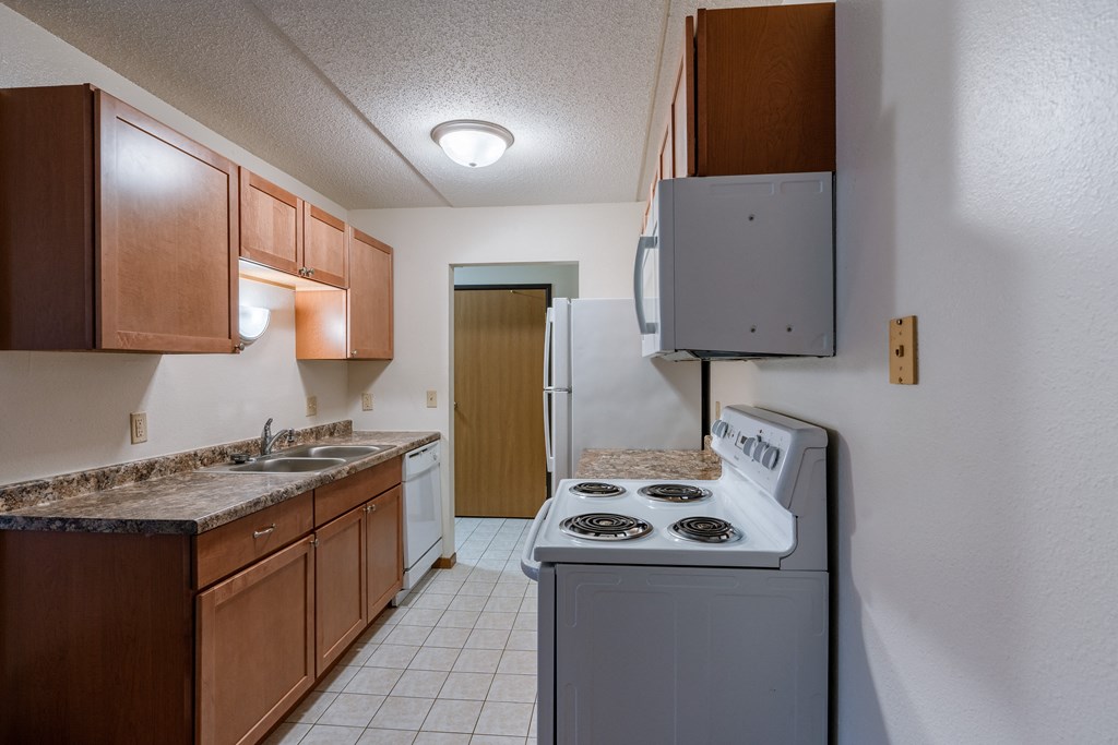 a kitchen with white tile flooring, white appliances at France, North Dakota