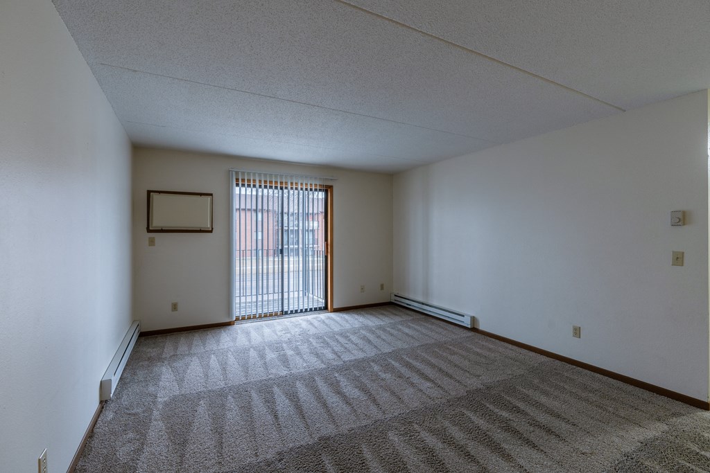 a living room with a glass sliding door at France, Fargo