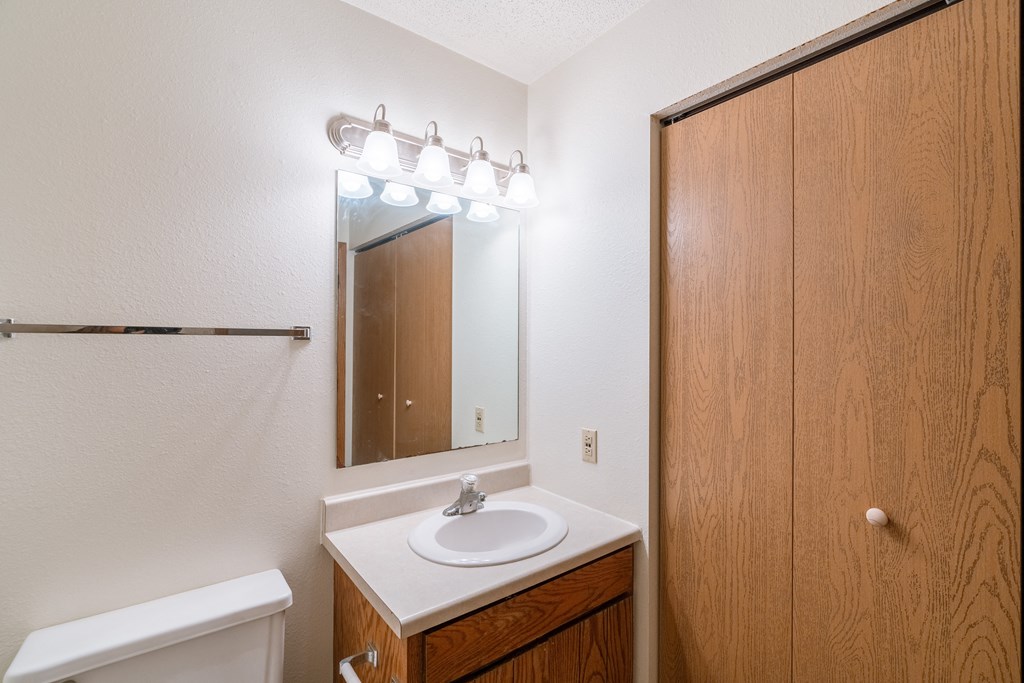 a bathroom with a sink and a mirror and a shower. Fargo, ND Galleria 3 Apartments