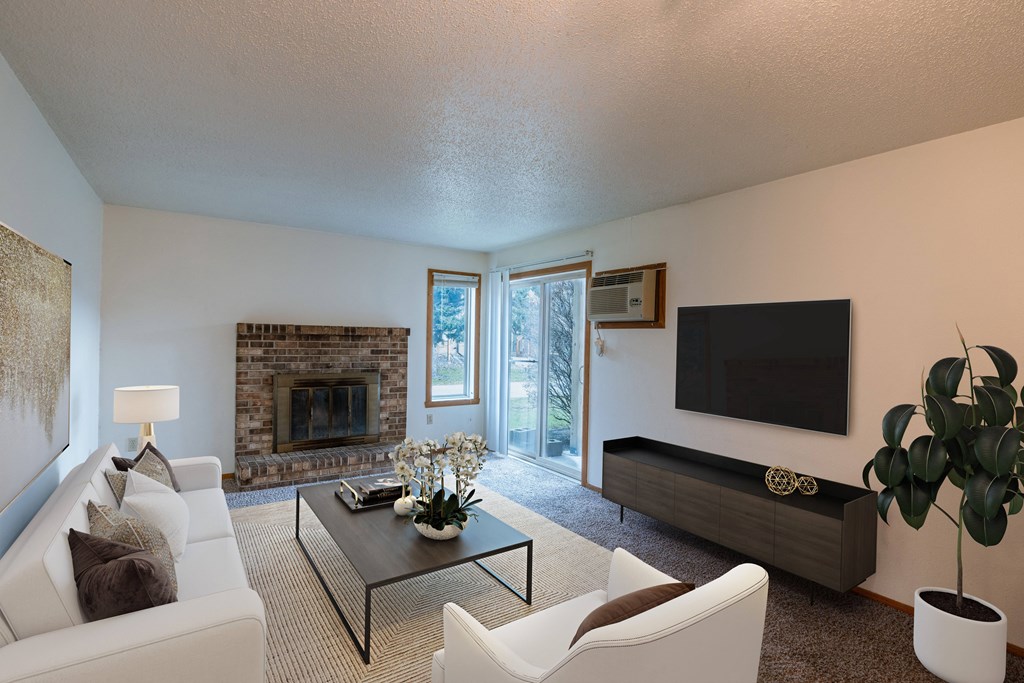 a living room with a couch and a tv and a fireplace. Fargo, ND Galleria 3 Apartments