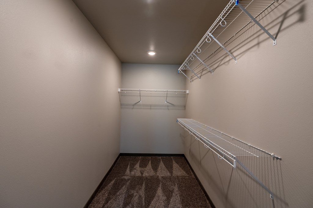 a walk in closet with shelves. Fargo, ND Granger Court Apartments.