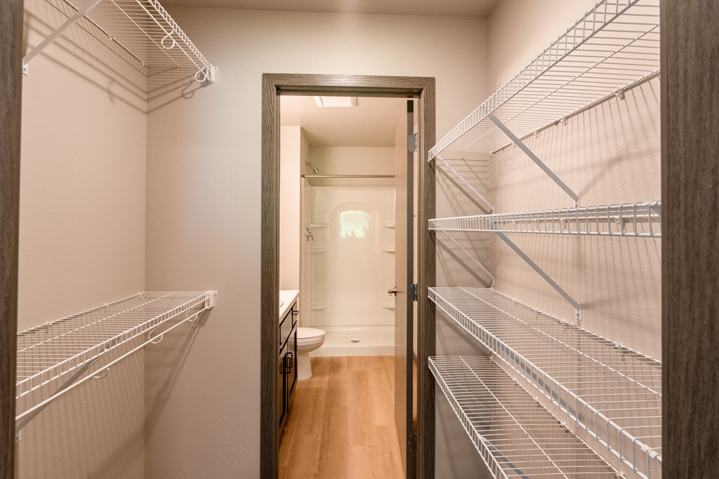 A large walk in closet in a home with metal shelves. Fargo, ND Granger Court Apartments.